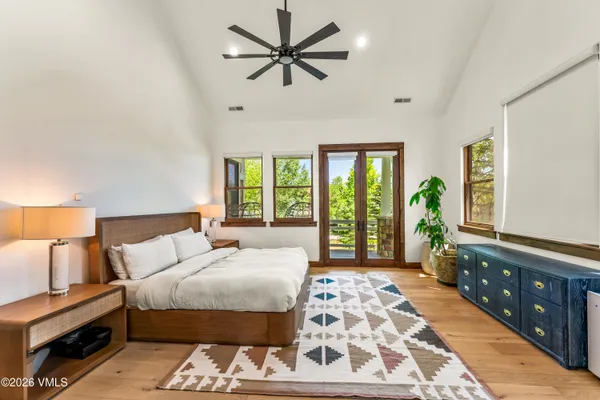 a living room with furniture a fireplace and a large window
