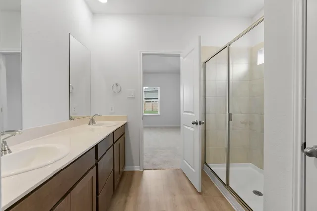 a view of an empty room and chandelier fan