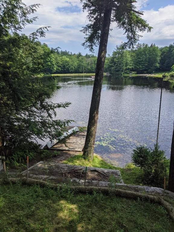 28 Farmhouse Road Chesterfield, MA 01012 - Photo 3 of 14 a view of a lake with a yard and large trees