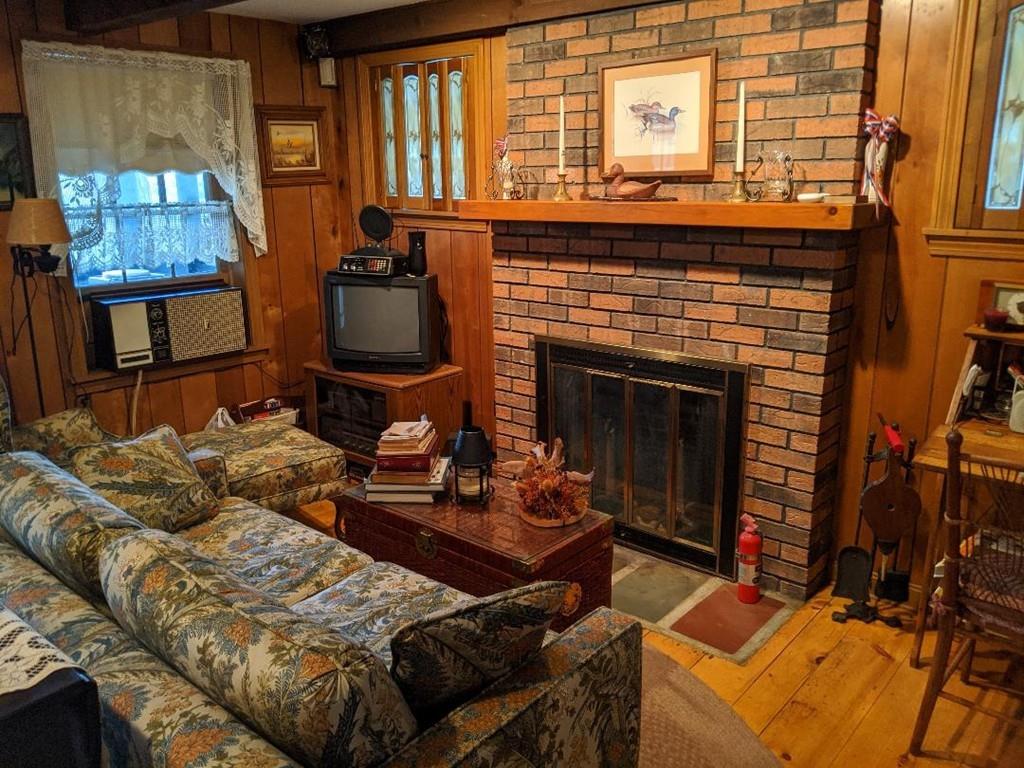 28 Farmhouse Road Chesterfield, MA 01012 - Photo 5 of 14 a living room with furniture a fireplace and windows