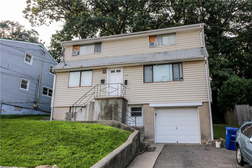 474 Merritt Street Bridgeport, CT 06606 - Photo 1 of 1 a front view of a house with a yard