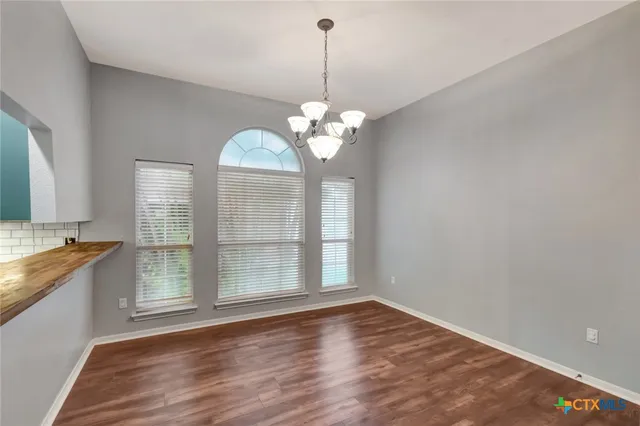 a view of a kitchen with granite countertop cabinets a sink and dishwasher