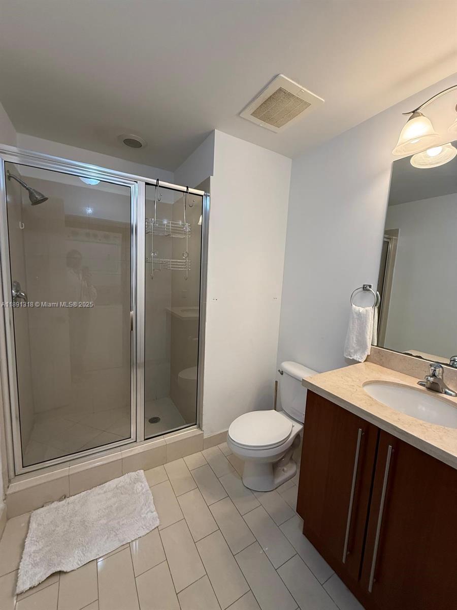 1111 Southwest 1st Avenue, Unit UPH4017 Miami, FL 33130 - Photo 11 of 14 a bathroom with a sink toilet and shower