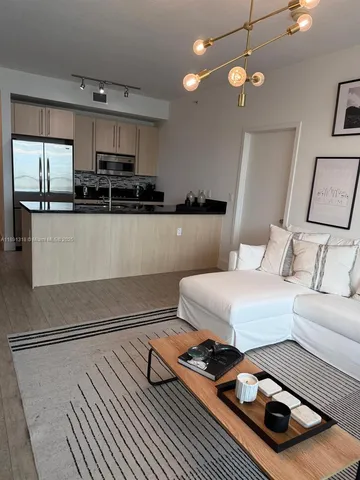 a kitchen with a sink a stove and cabinets