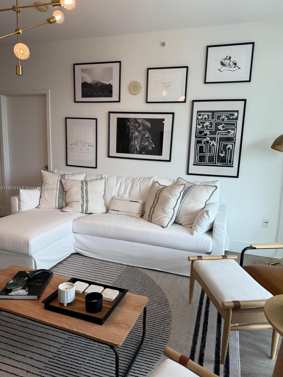 1111 Southwest 1st Avenue, Unit UPH4017 Miami, FL 33130 - Photo 6 of 14 a bedroom with furniture and wooden floor