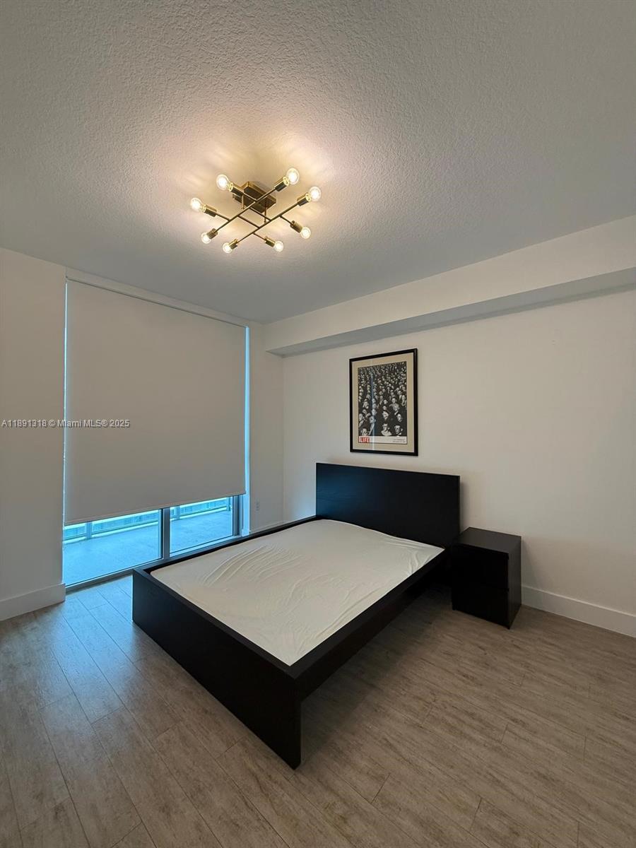 1111 Southwest 1st Avenue, Unit UPH4017 Miami, FL 33130 - Photo 10 of 14 a living room with hard wood floors