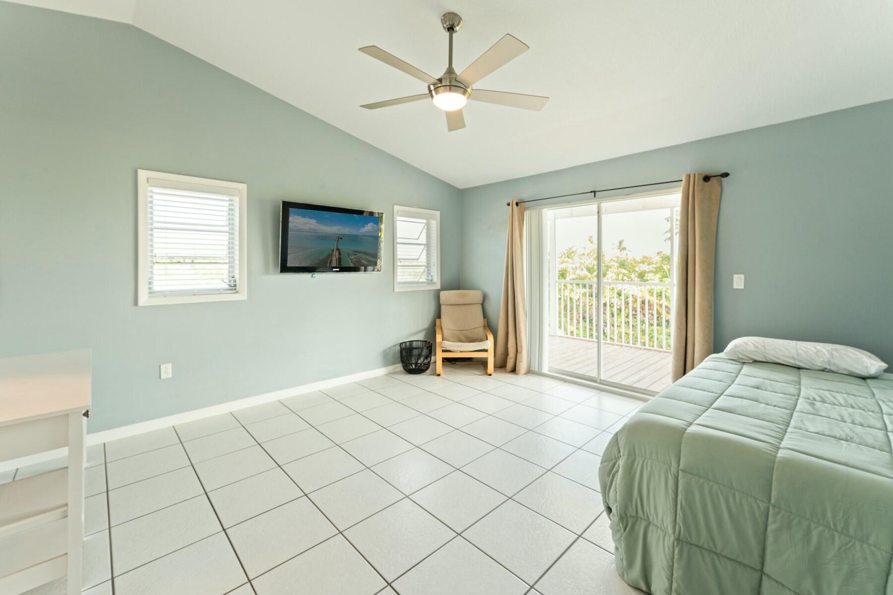 1010 Snapper Lane Key Largo, FL 33037 - Photo 15 of 26 a bed room with a bed and a tv
