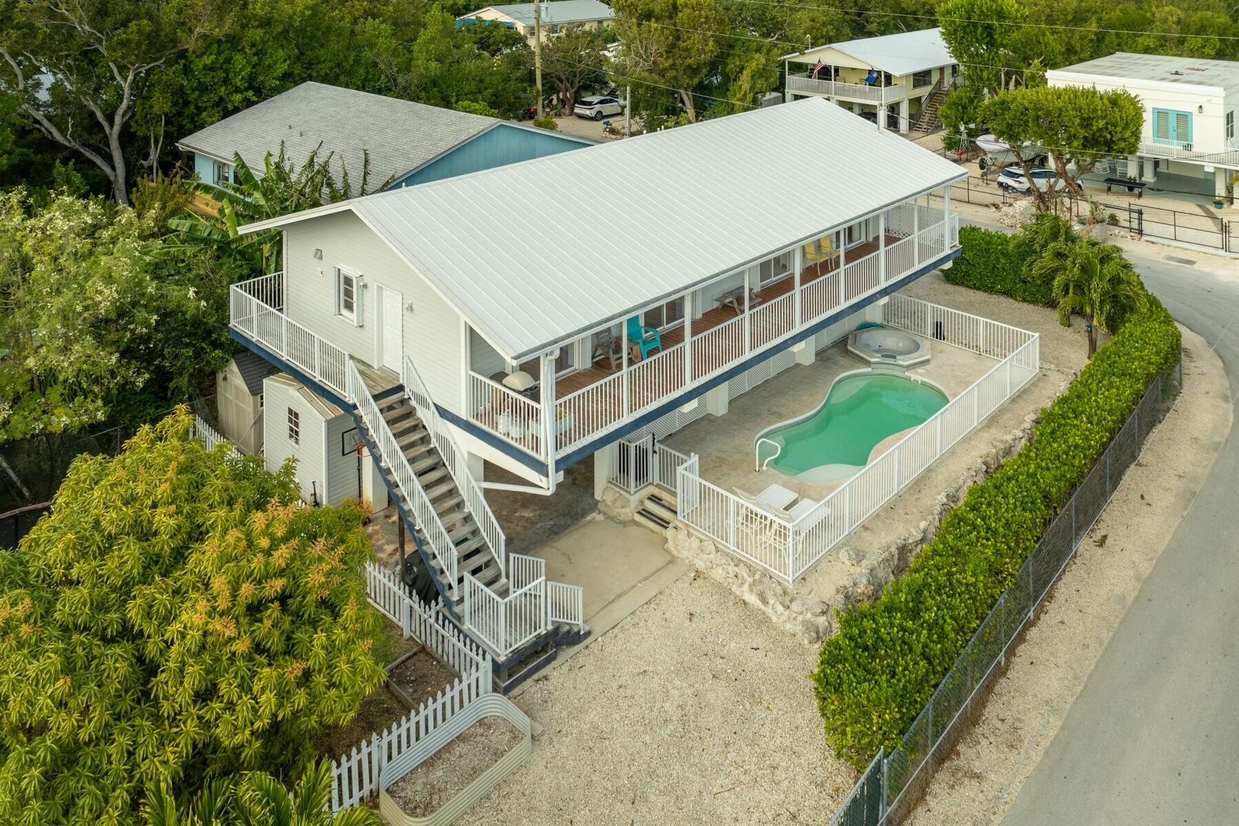 1010 Snapper Lane Key Largo, FL 33037 - Photo 2 of 26 a aerial view of a house with a yard