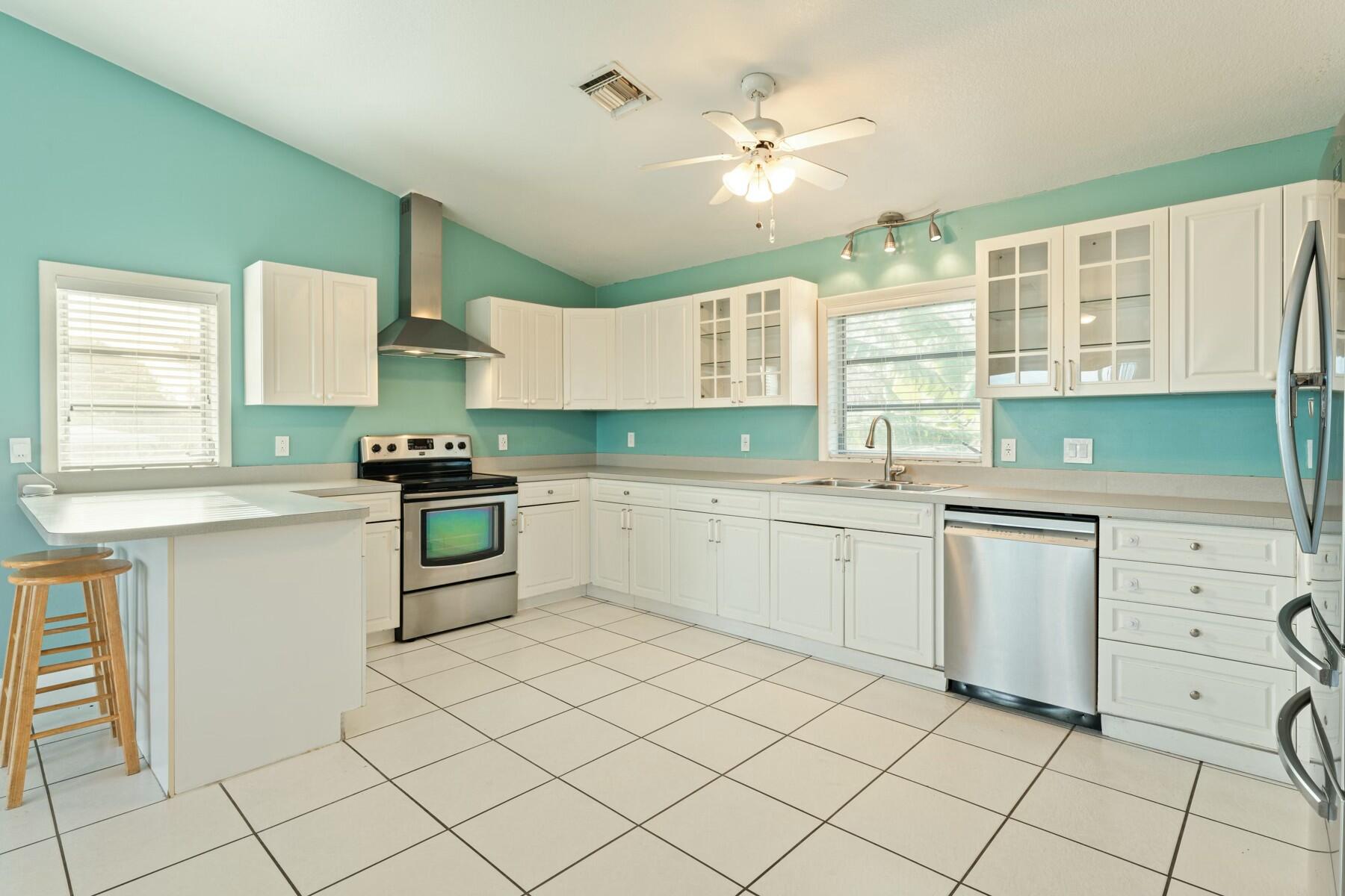 1010 Snapper Lane Key Largo, FL 33037 - Photo 6 of 26 a kitchen with white cabinets appliances and a window