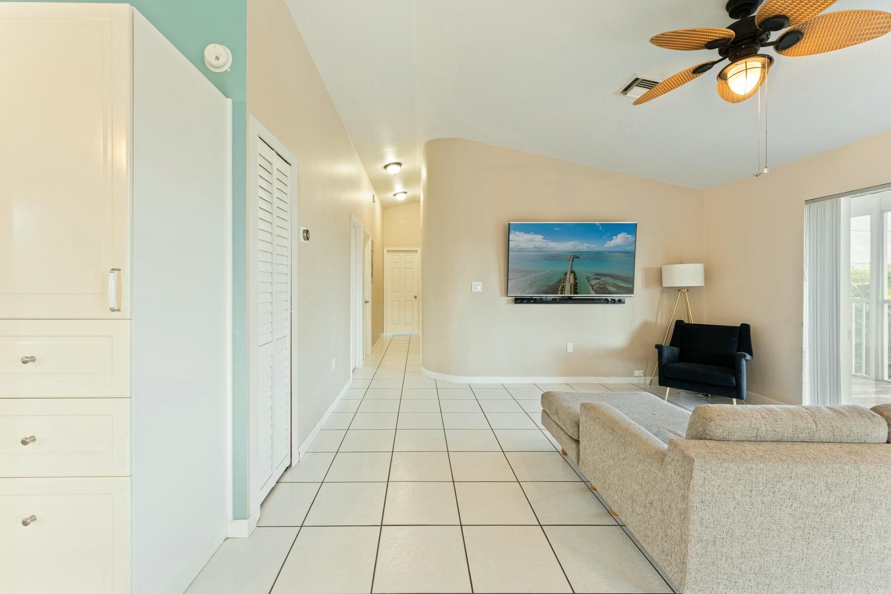 1010 Snapper Lane Key Largo, FL 33037 - Photo 10 of 26 a living room with a couch and a flat screen tv