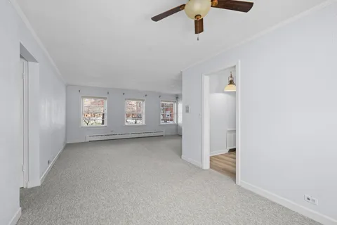 an empty room with windows and closet