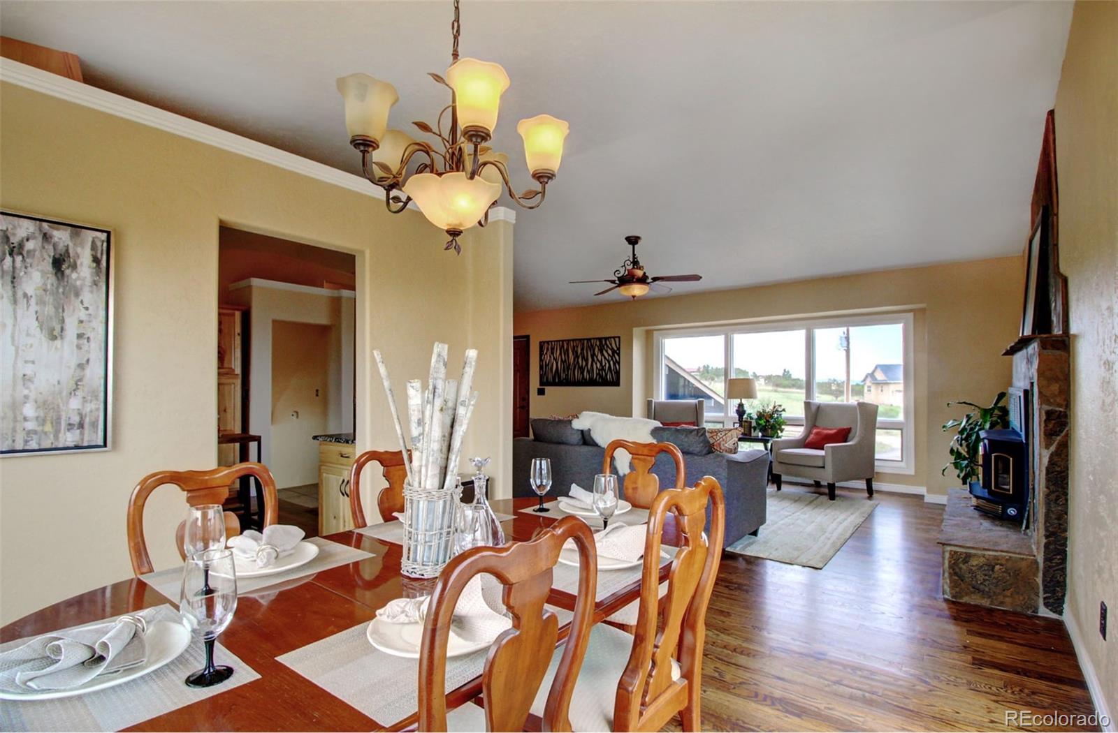 4345 Evans Road Monument, CO 80132 - Photo 11 of 40 a view of a dining room with furniture wooden floor and chandelier