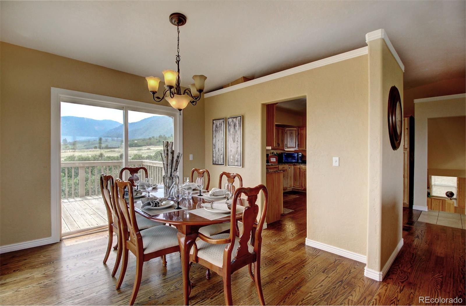 4345 Evans Road Monument, CO 80132 - Photo 21 of 40 a dining room with furniture window wooden floor