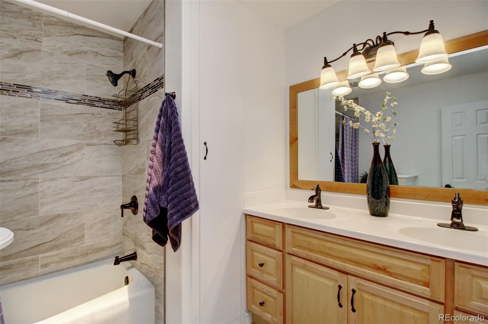 4345 Evans Road Monument, CO 80132 - Photo 23 of 40 a bathroom with a sink a vanity and a mirror