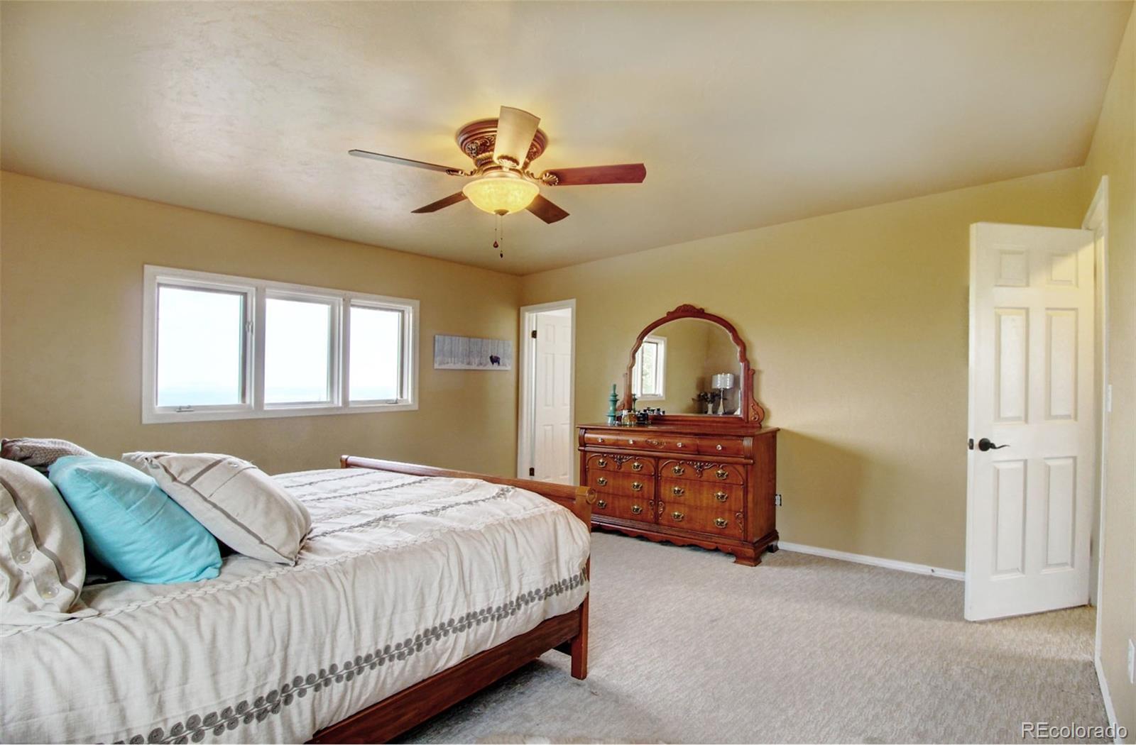 4345 Evans Road Monument, CO 80132 - Photo 25 of 40 a bedroom with a bed and a dresser