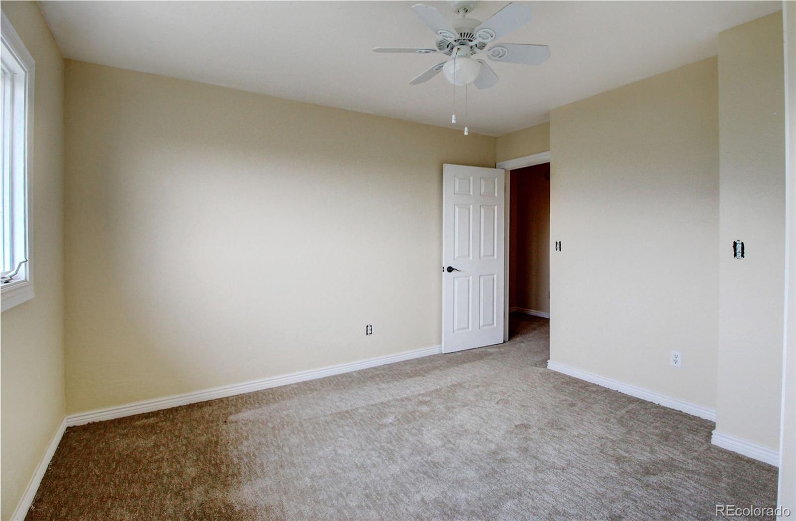 4345 Evans Road Monument, CO 80132 - Photo 29 of 40 an empty room with a ceiling fan and a window