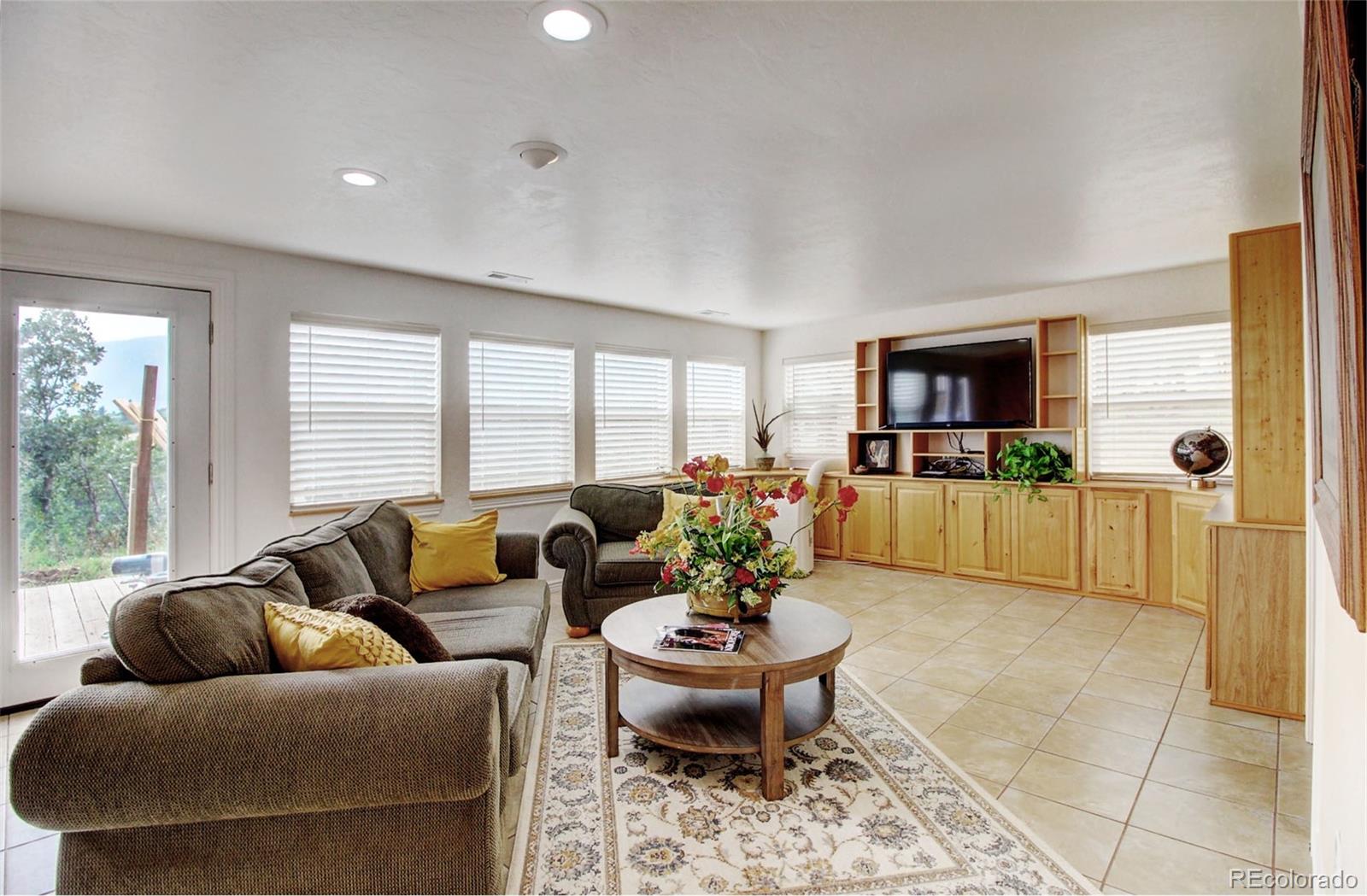 4345 Evans Road Monument, CO 80132 - Photo 30 of 40 a living room with furniture and a wooden floor