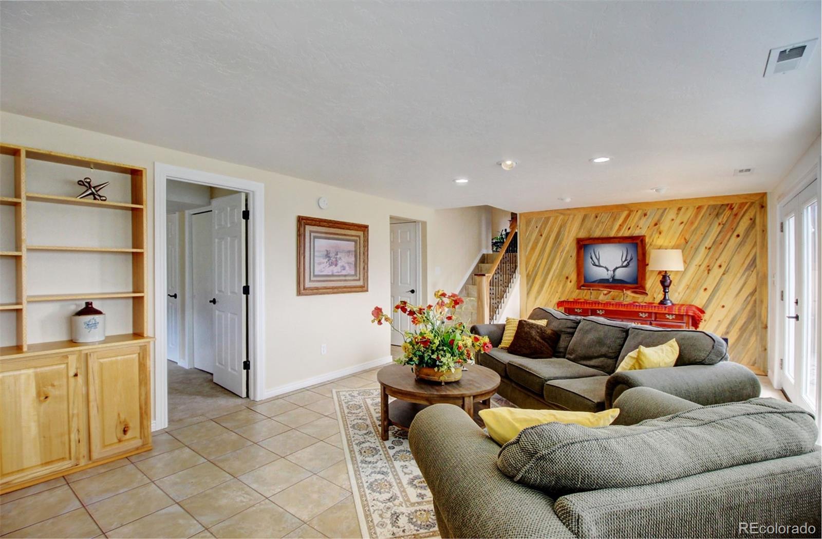 4345 Evans Road Monument, CO 80132 - Photo 32 of 40 a living room with furniture and a flat screen tv