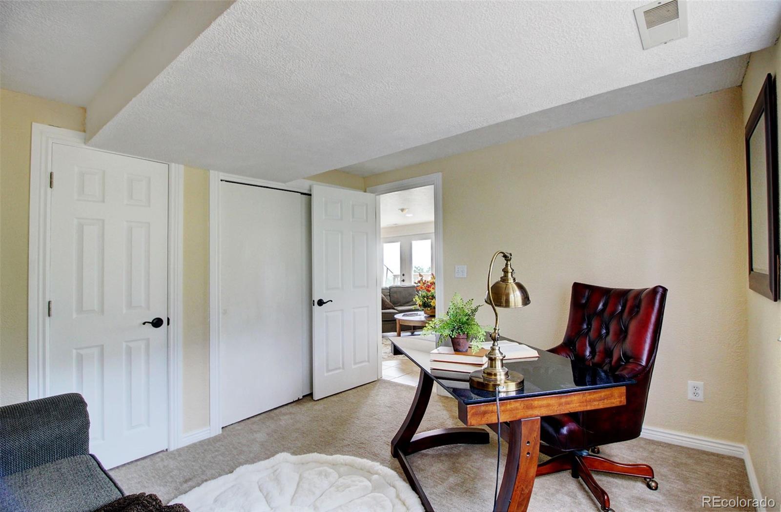 4345 Evans Road Monument, CO 80132 - Photo 34 of 40 a workspace room with furniture and wooden floor