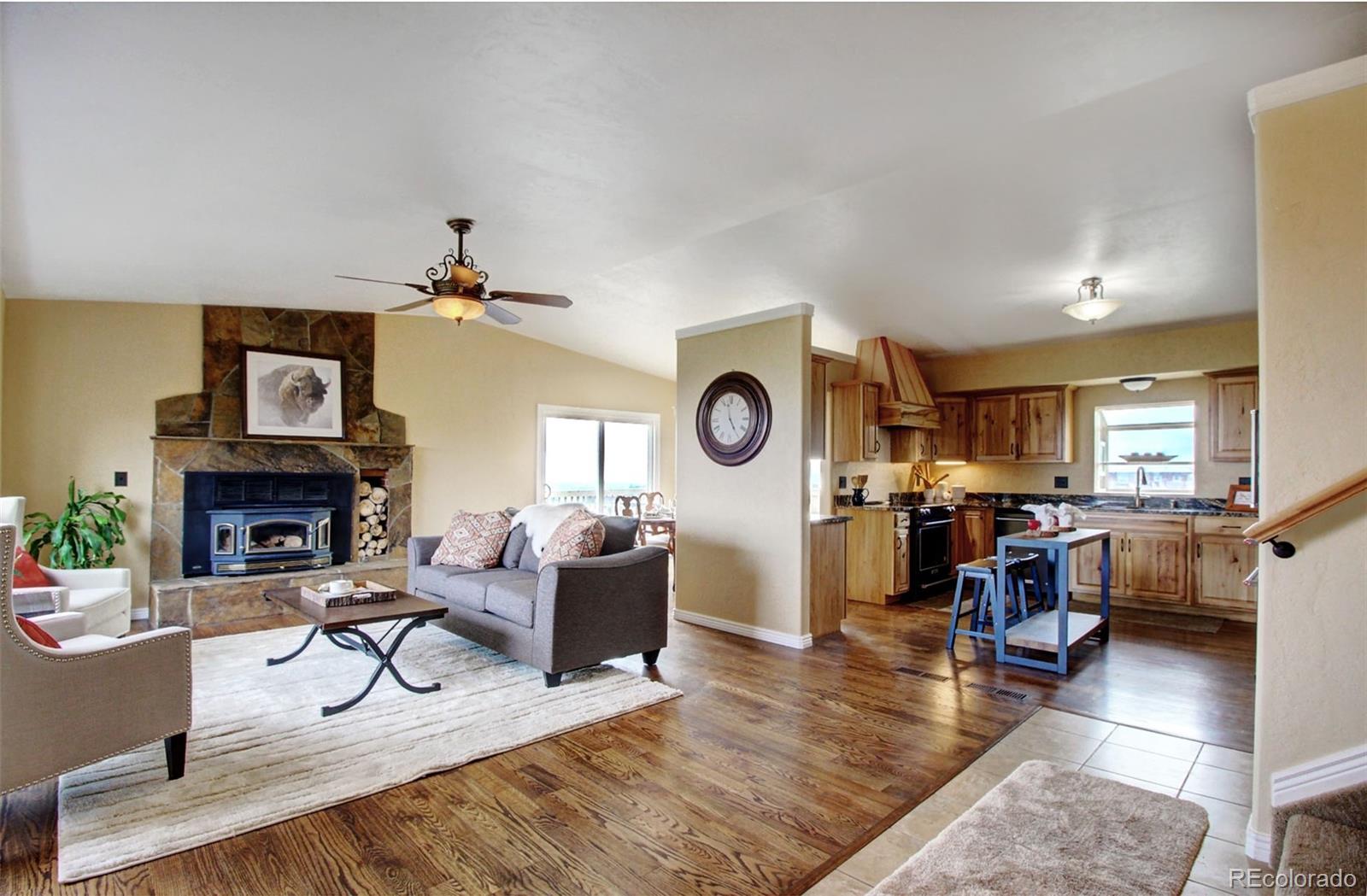 4345 Evans Road Monument, CO 80132 - Photo 4 of 40 a view of a livingroom with furniture and a fireplace