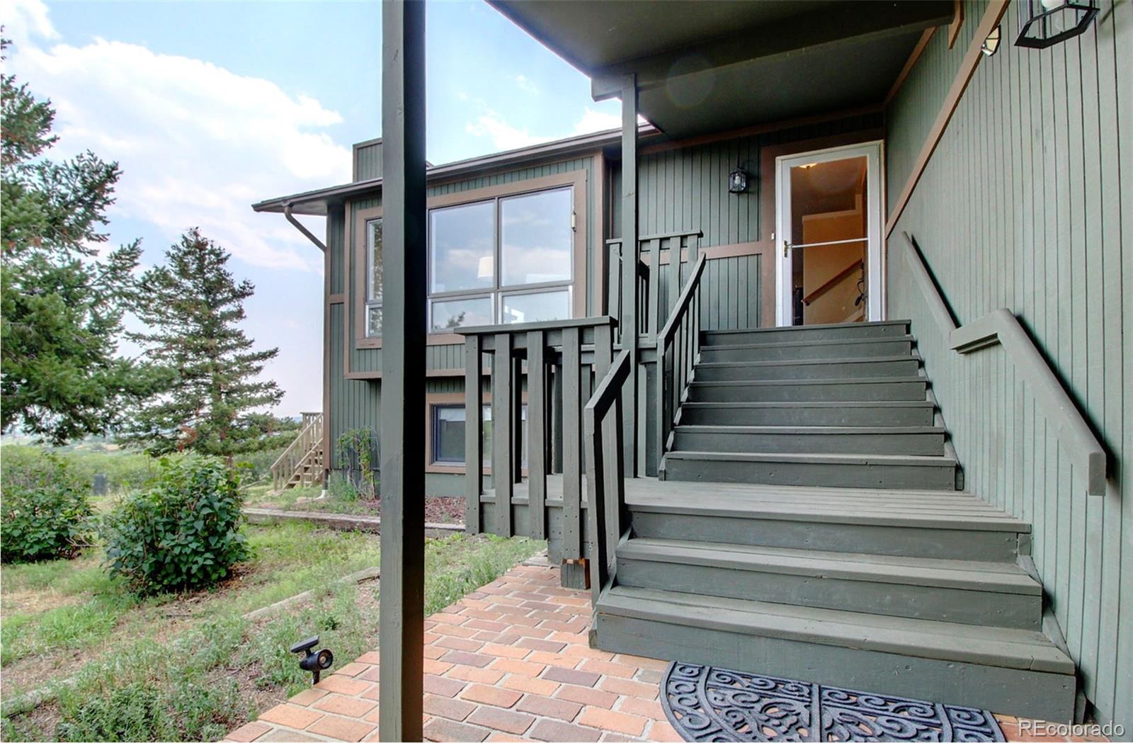 4345 Evans Road Monument, CO 80132 - Photo 5 of 40 a view of staircase with wooden floor and fence