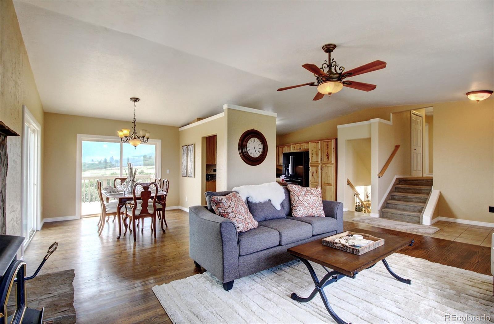4345 Evans Road Monument, CO 80132 - Photo 9 of 40 a living room with furniture and a wooden floor