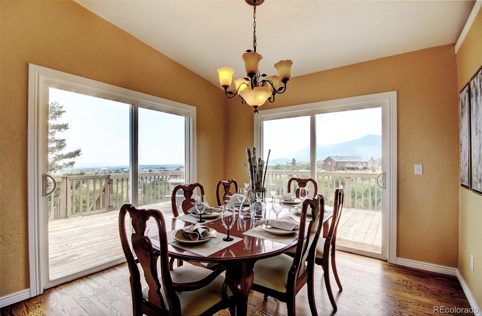 4345 Evans Road Monument, CO 80132 - Photo 10 of 40 a view of a dining room with furniture window and wooden floor