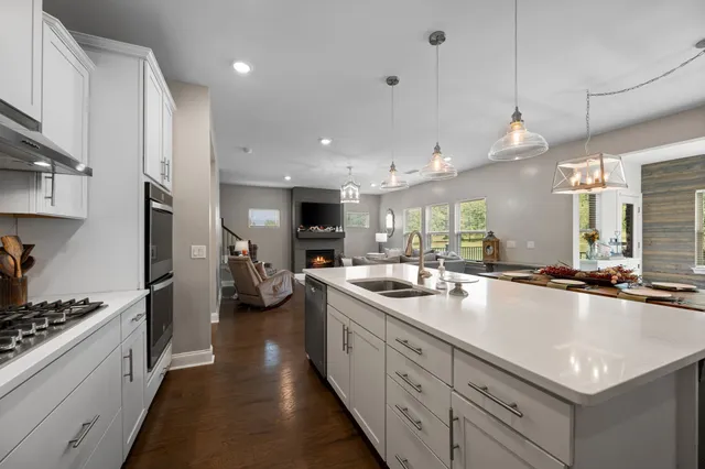 a living room with furniture a window and a dining table with wooden floor