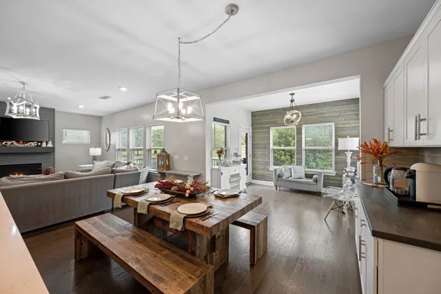 a view of a patio with couches table and chairs and potted plants
