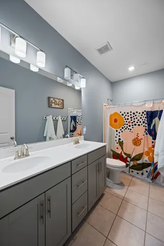 an aerial view of residential houses with outdoor space and ocean view