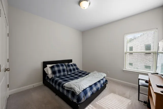 a blue swimming pool with an outdoor space and seating area