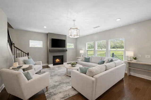 a living room with furniture and a chandelier