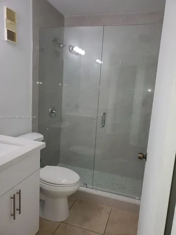 a bathroom with a toilet a sink and shower