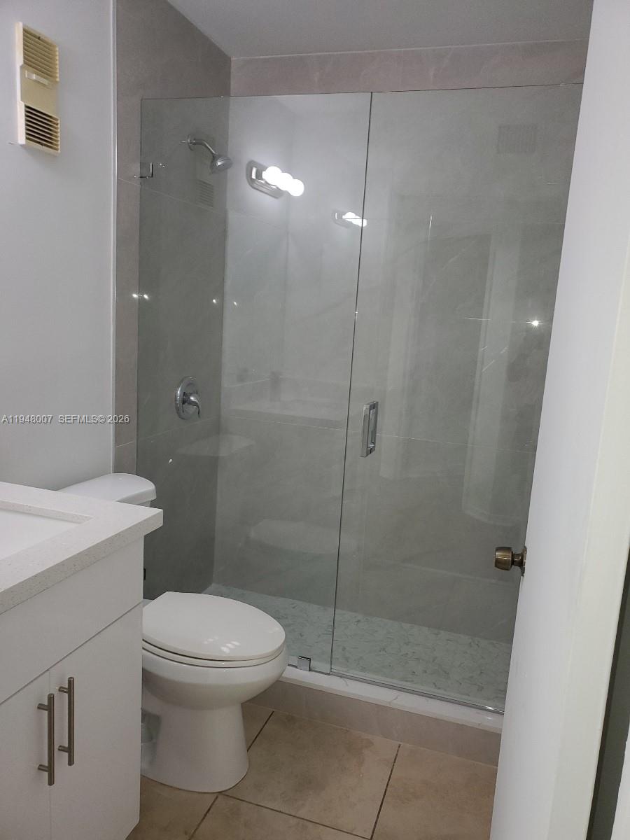 15241 Southwest 80th Street, Unit 307 Miami, FL 33193 - Photo 8 of 11 a bathroom with a toilet a sink and shower