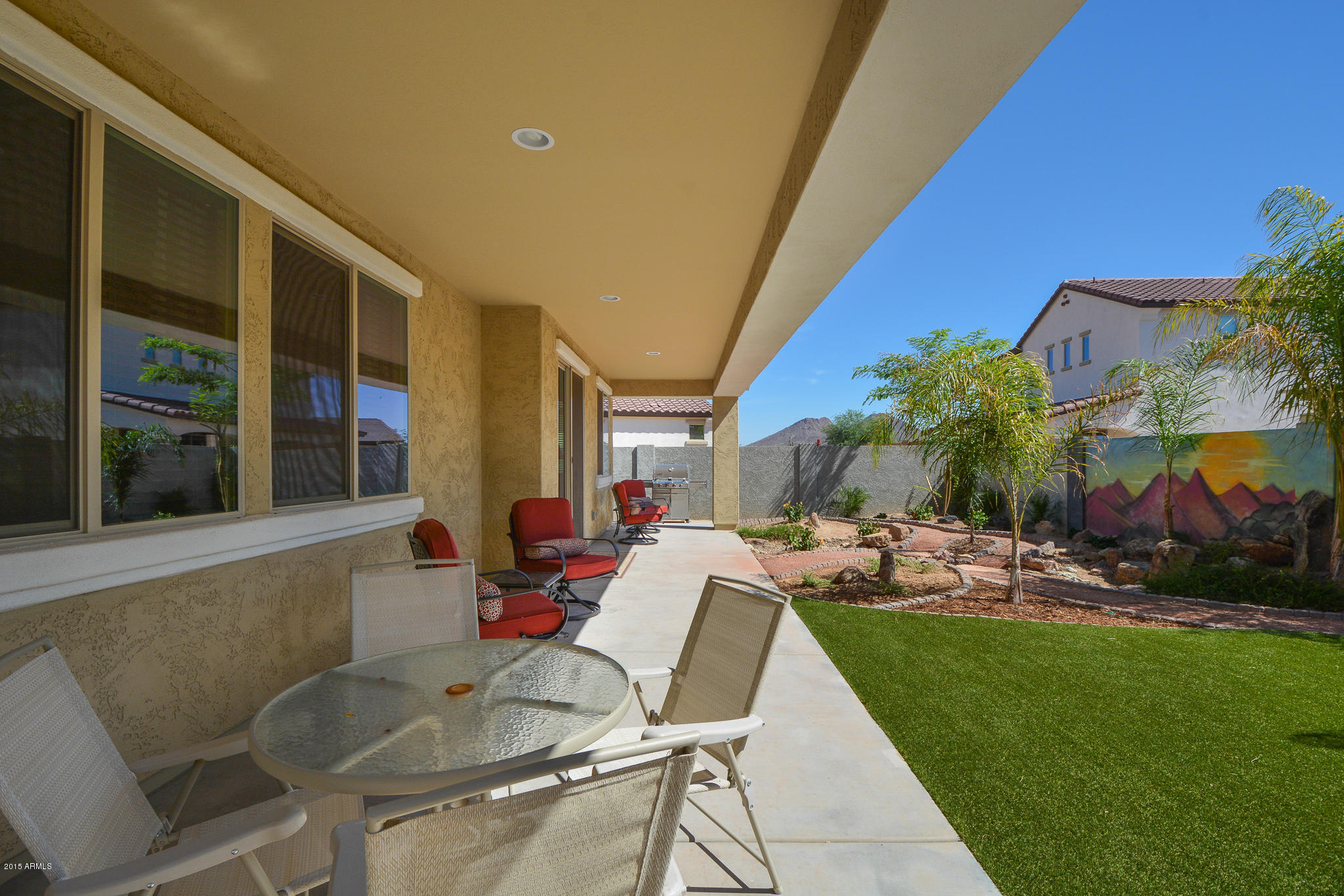 7545 West Redbird Road Peoria, AZ 85383 - Photo 17 of 23 a view of a house with backyard sitting area and garden