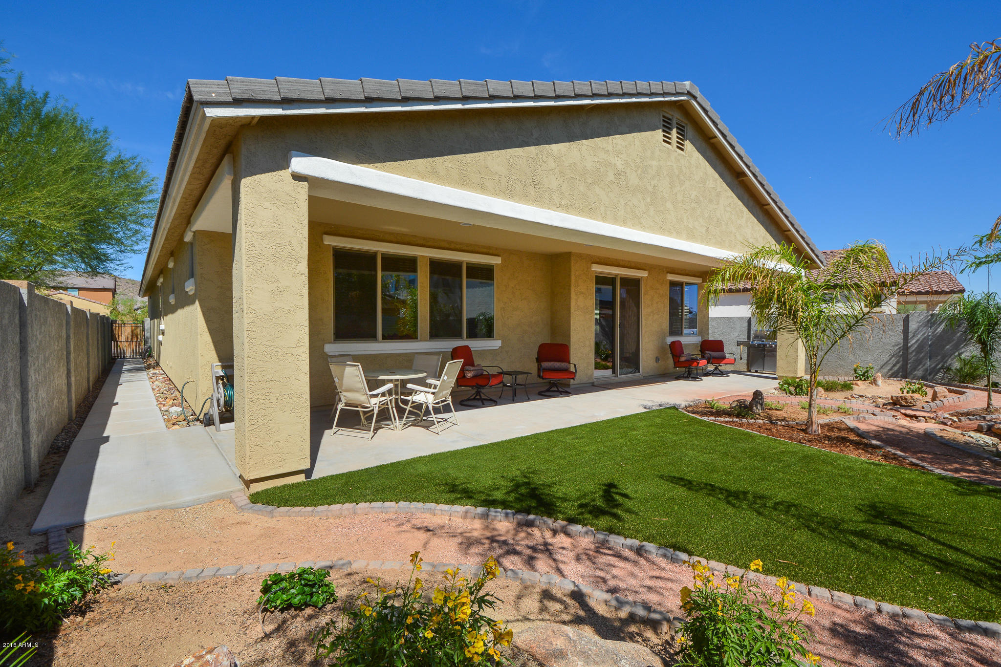 7545 West Redbird Road Peoria, AZ 85383 - Photo 2 of 23 a view of a house with backyard porch and sitting area