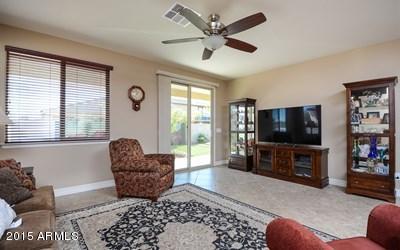 7545 West Redbird Road Peoria, AZ 85383 - Photo 7 of 23 a living room with furniture and a flat screen tv