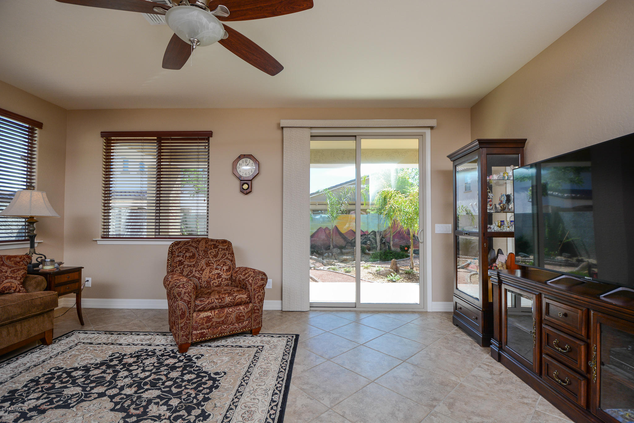 7545 West Redbird Road Peoria, AZ 85383 - Photo 8 of 23 a living room with furniture a flat screen tv and a window