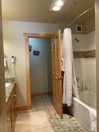a bathroom with a tub and shower