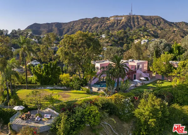an aerial view of a house with a yard basket ball court and outdoor seating