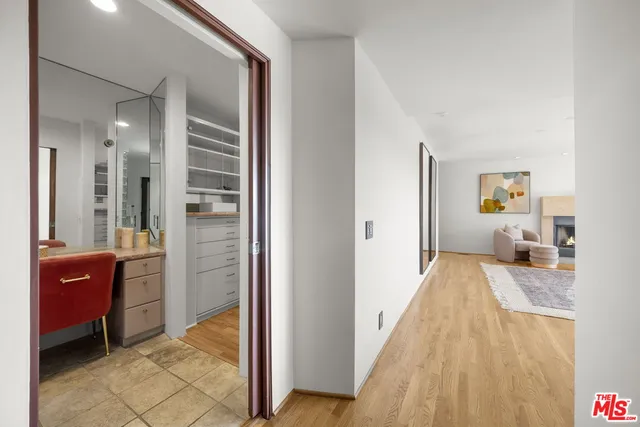a view of a bedroom with a bed and wooden floor