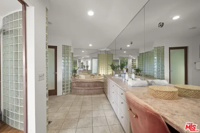 a bedroom with furniture and a large window