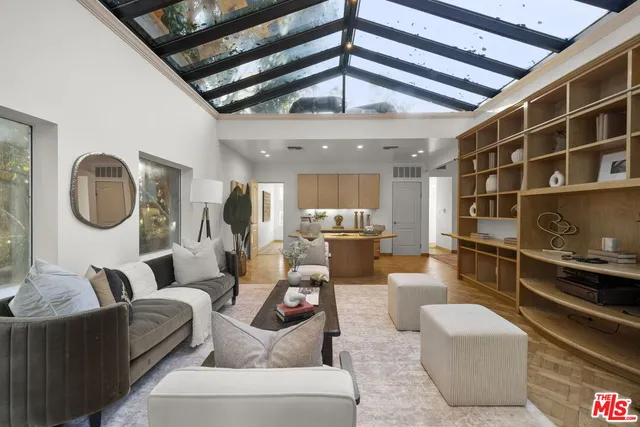 a spacious bedroom with a bed a table and painting