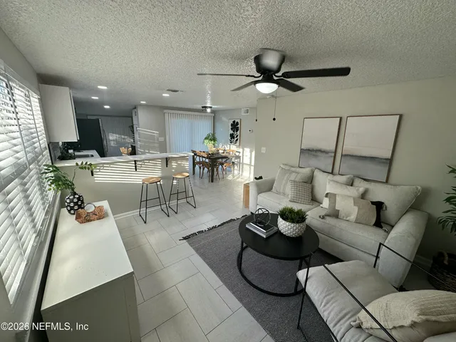 a living room with furniture and a large window