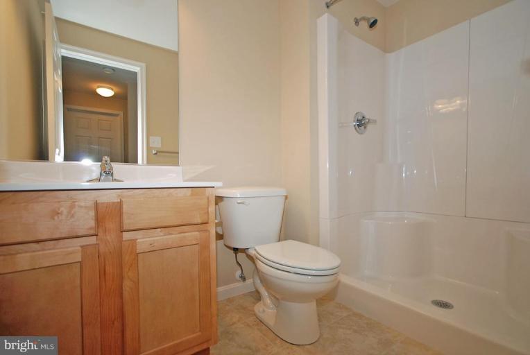 5970 Florey Road Hanover, MD 21076 - Photo 26 of 30 a bathroom with a granite countertop sink toilet and shower