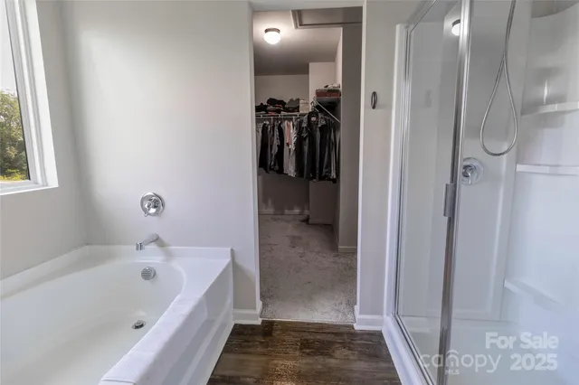 a bathroom with a bathtub and a shower