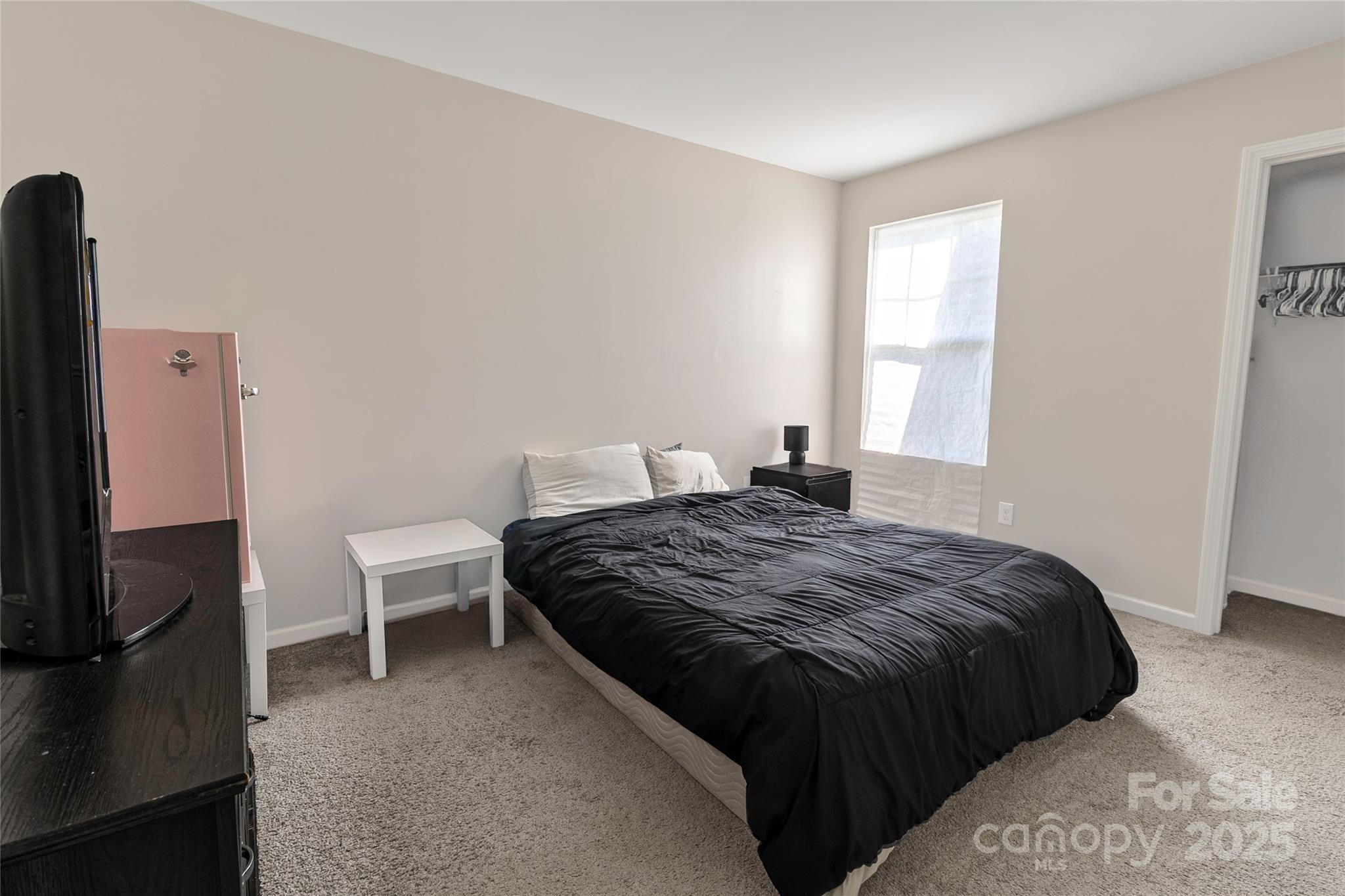 7017 Whitewater Loop Lowell, NC 28098 - Photo 18 of 24 a bedroom with a bed and a tv on the dresser