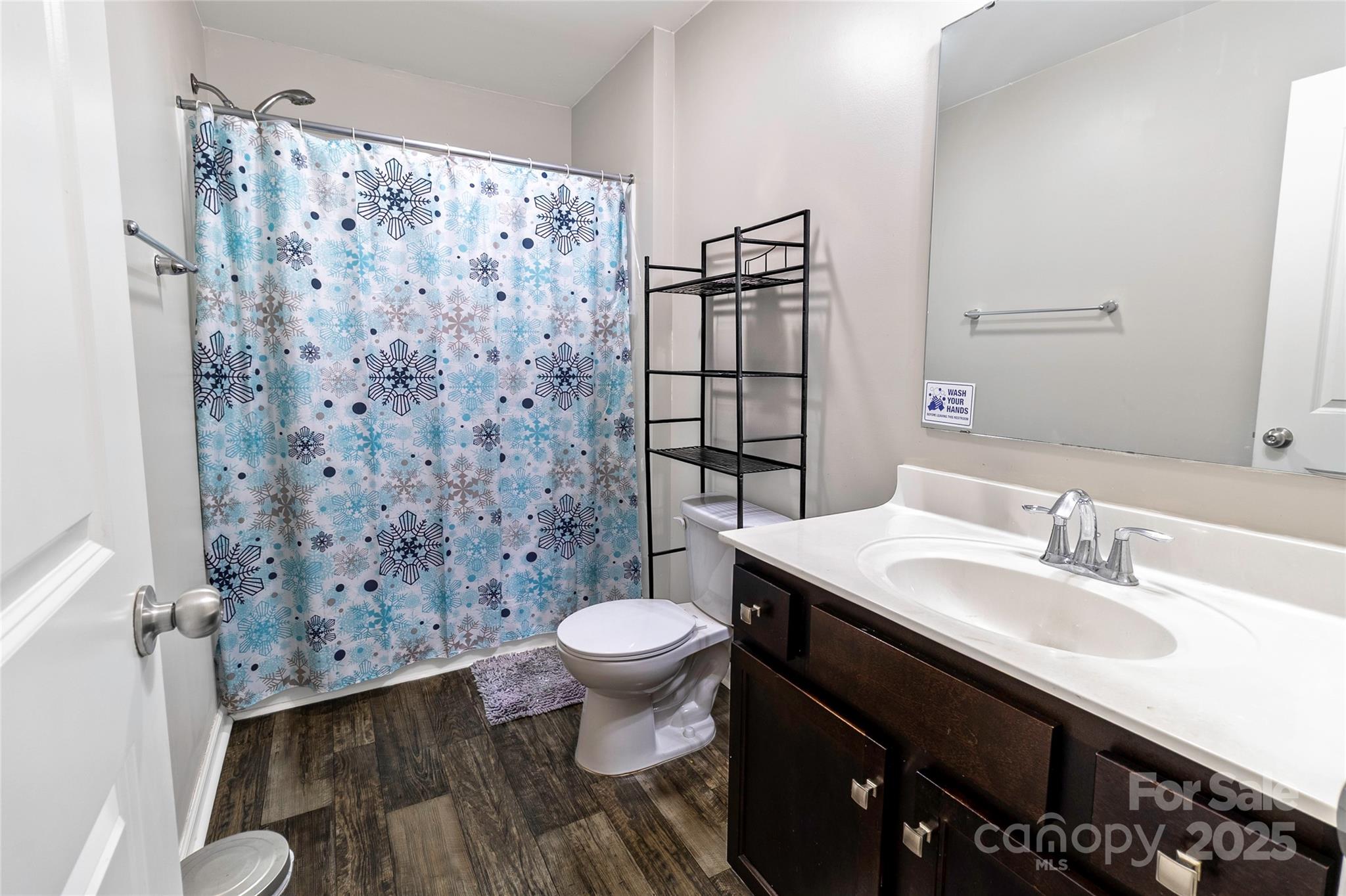 7017 Whitewater Loop Lowell, NC 28098 - Photo 19 of 24 a bathroom with a sink toilet a mirror and shower