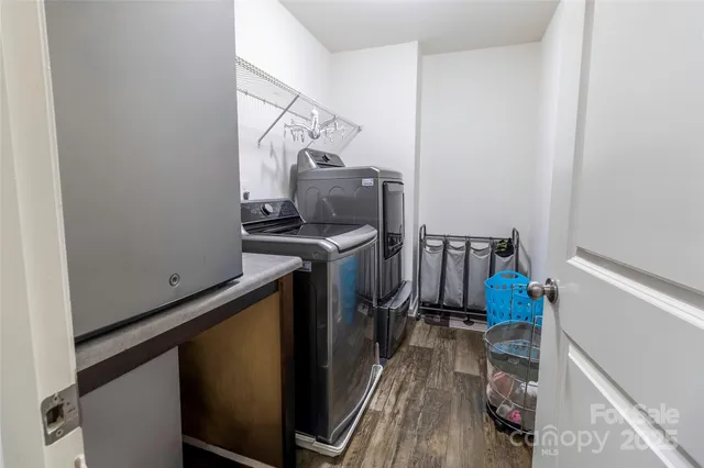 a view of a storage and utility room with two washing machine