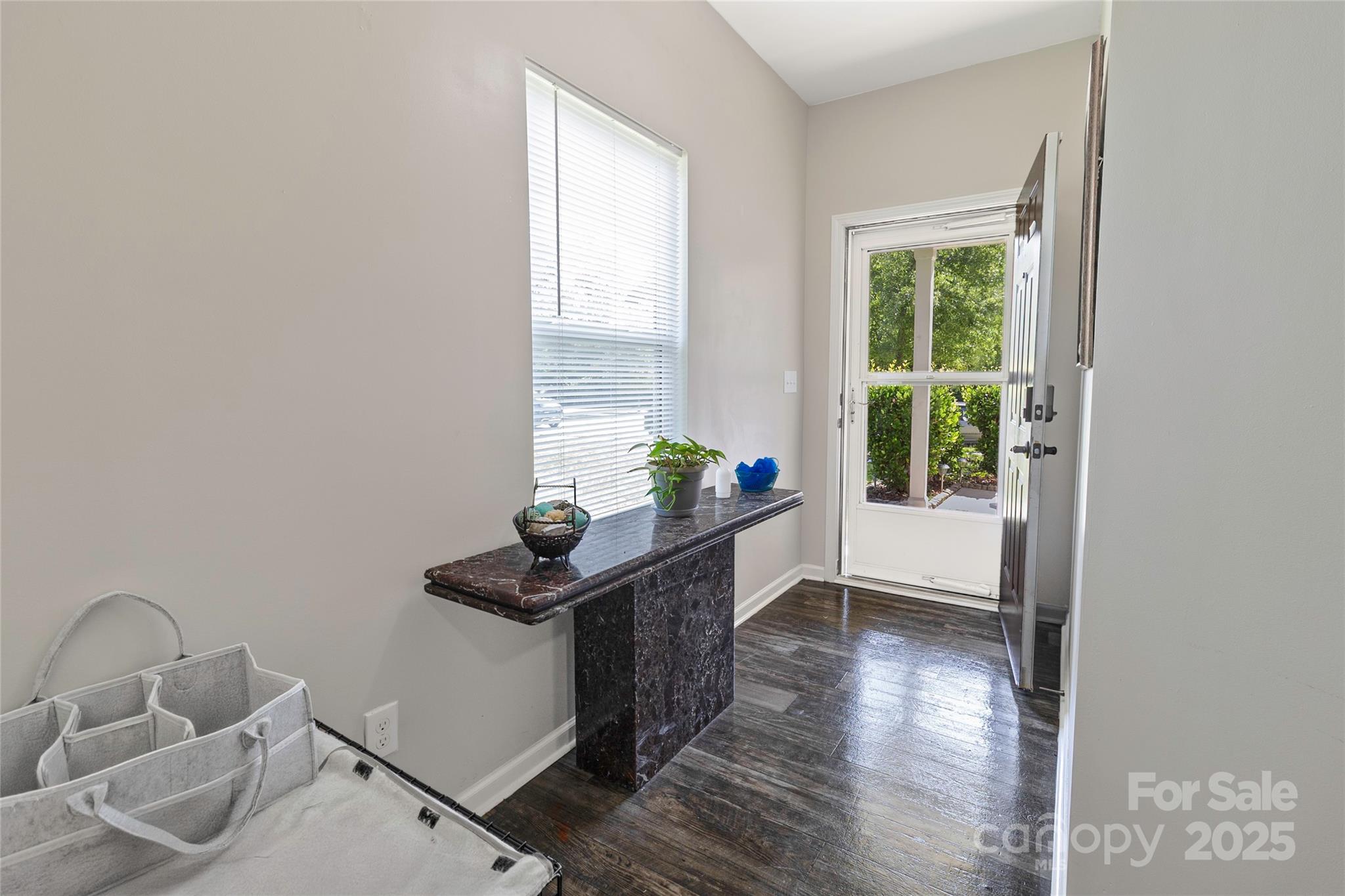 7017 Whitewater Loop Lowell, NC 28098 - Photo 2 of 24 a hallway with a wooden floor and a potted plant
